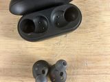 an image of a pair of ear buds sitting on top of a wooden table
