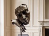 a sculpture of a woman ' s head on a table