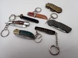 many different types of key chains on a white surface