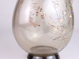 a clear glass pitcher with a floral design on it