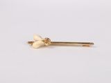a pair of gold nose studs with white pearls on them