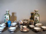 many different types of vases and bowls on the table