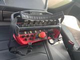 an image of a car seat with a bunch of tools in it