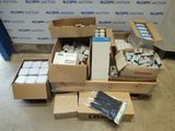 several boxes of assorted items sitting on a floor in front of a wall