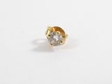a close up of a single diamond ring on a white surface