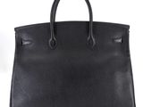 a black leather handbag on a white background