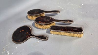 three brushes sitting on top of a table next to each other