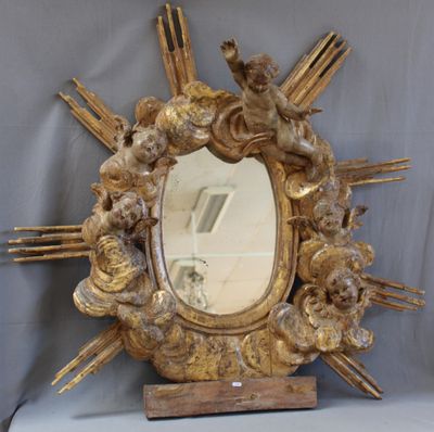 a mirror that has angels on it and a starburst in the middle