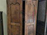 a wooden armoire with a mirror on top of it