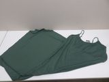 a green top and a green pants on a white table