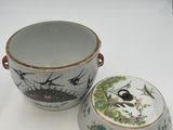 two cups and a bowl sitting on a white surface