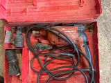 a red tool box with tools in it on the floor