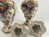 two vases sitting next to each other on a table