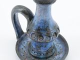 a blue vase that is sitting on a saucer