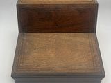 an old wooden box sitting on top of a white surface