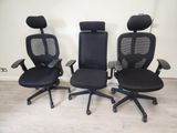 trois chaises de bureau noires posées sur un parquet en bois massif
