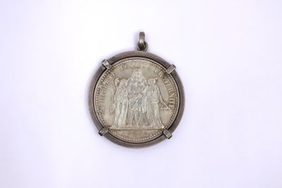 a silver coin with a picture of a man on it