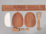 a piece of wood with a knife, spoon, and spoon rest on it