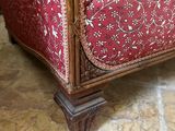 an image of a red and white couch with pillows on it