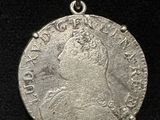 a close up of a silver coin on a black surface