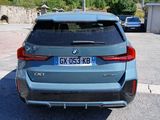 a blue bmw suv parked on the side of the road