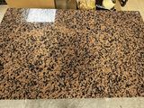 a brown and black rug on the floor of a kitchen