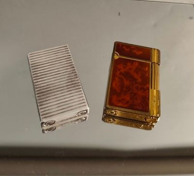 two lighters sitting on top of a table next to each other