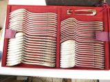 a red box with silverware in it on a table