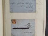 two pieces of paper with stamps on them hanging on a wall
