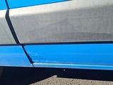 a close up of a blue car with a flat tire
