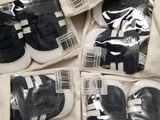 several pairs of black and white baby shoes are in a bag