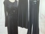 two dresses on a mannequin stand in front of a white wall