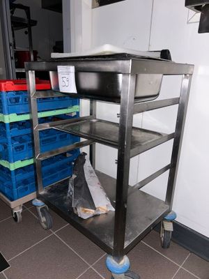 a metal cart with a bunch of plastic bins on it