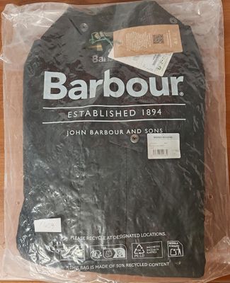 a barbour t - shirt wrapped in plastic on a table