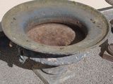 a dirty toilet sitting on the ground next to a pair of shoes