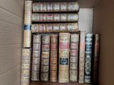 a box full of old books sitting on a shelf