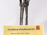 a statue of a man holding a pole and a certificate