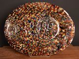 a plate with a design on it sitting on a wooden table