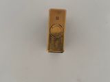a gold lighter sitting on top of a white table