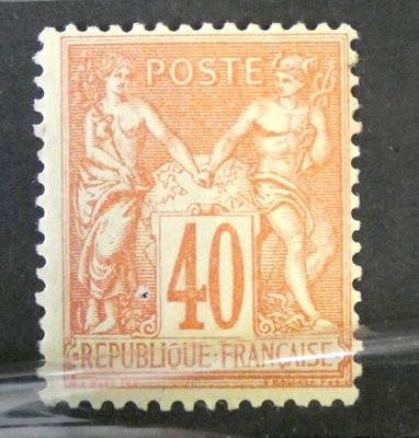 un timbre orange et noir sur lequel figure l'image d'une femme