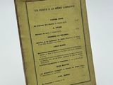 an old book sitting on top of a table next to a white background