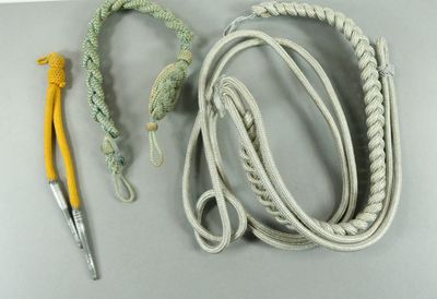 a rope, a crochet, and a crochet hook on a table