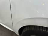 a close up of a white car with a flat tire