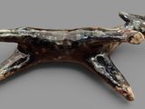 an image of a sculpture of a cat laying on its back