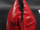 a close up of a red boxing bag on a table