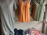 three mannequins in a closet with clothes on display