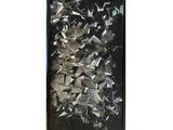 black and white photograph of a picture of shattered glass on a wall