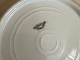 a white plate with a bird on it sitting on a table