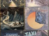 several albums of heavy rock and heavy metal music are on a table