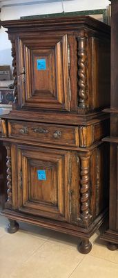 two wooden cabinets that are stacked on top of each other
